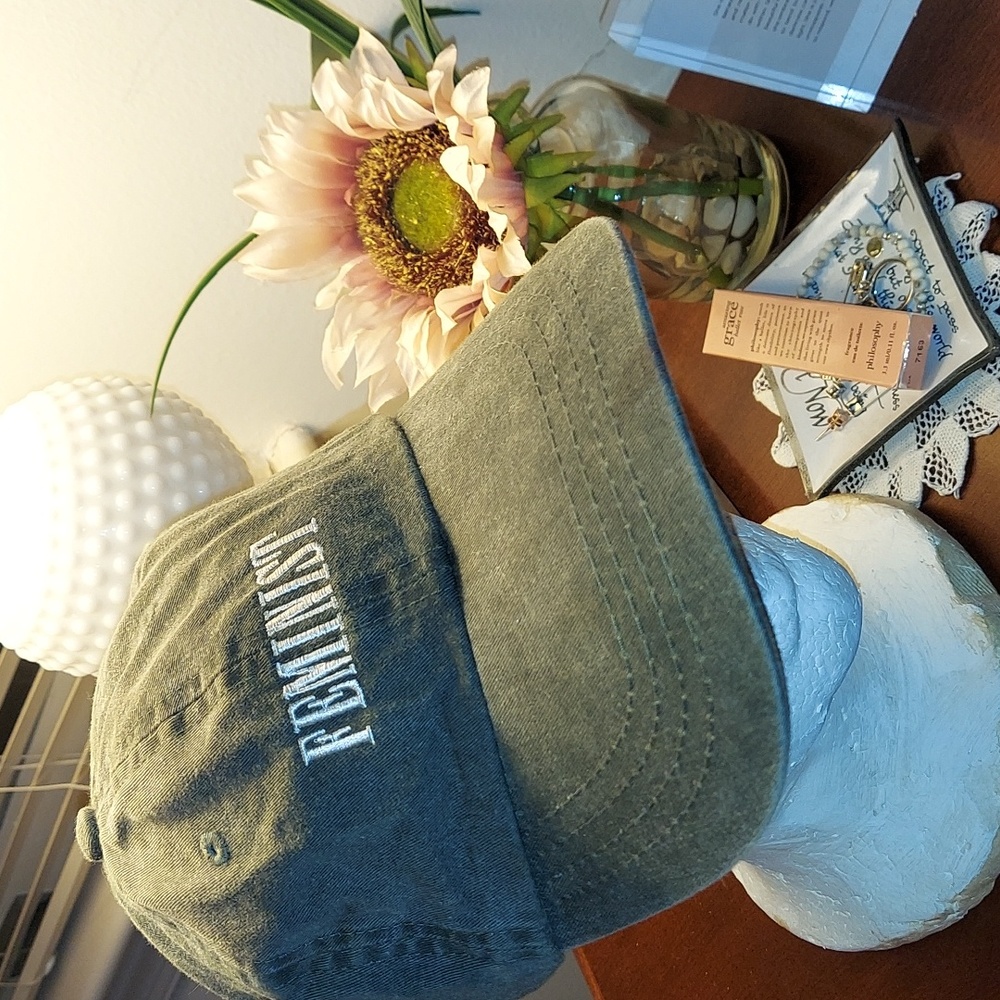 Gray ball cap with word "Feminist" in white font